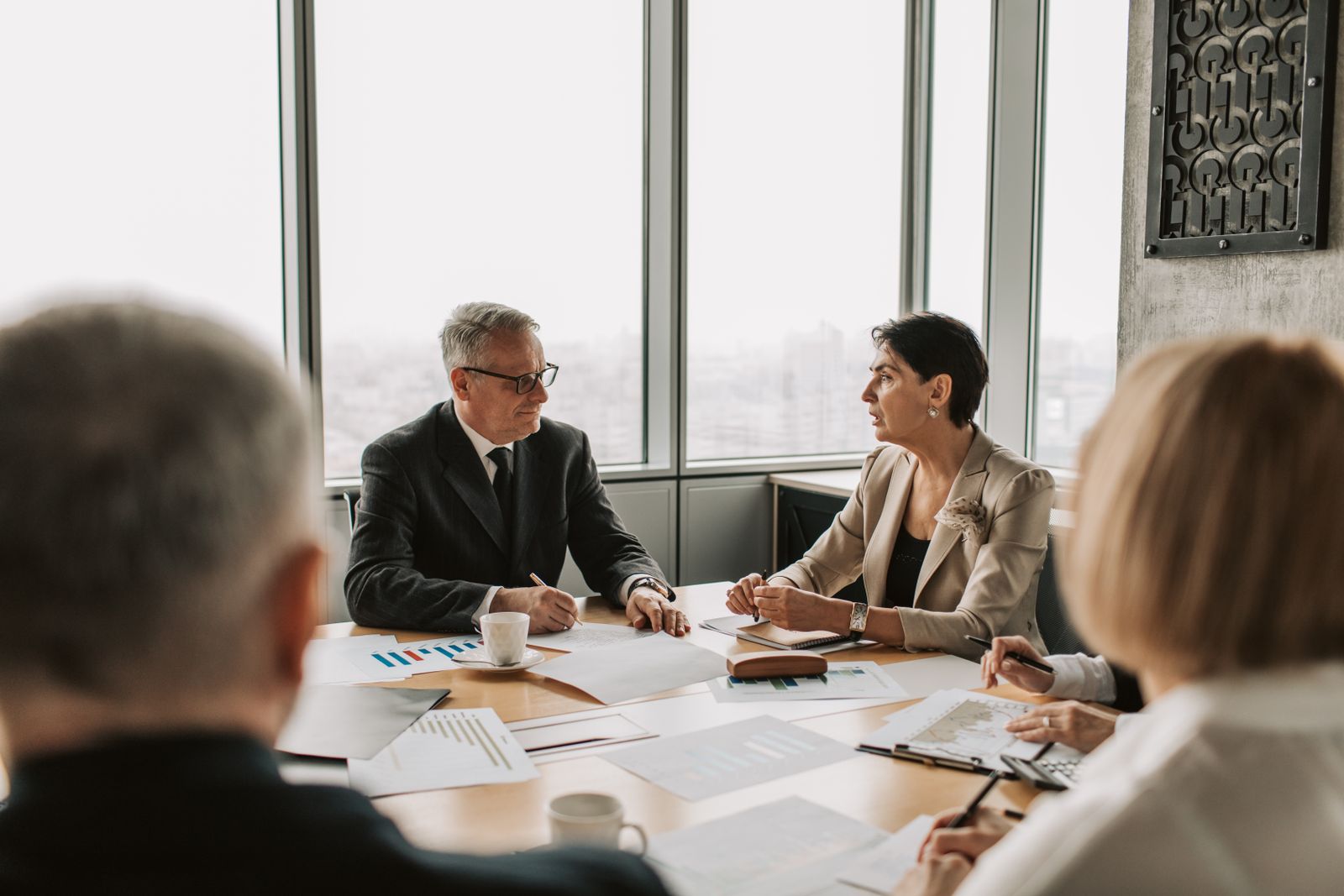 Senior executives in discussion at a boardroom table